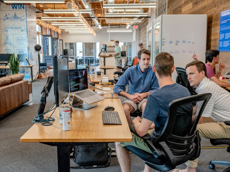 A leadership team reviewing plans in a boardroom